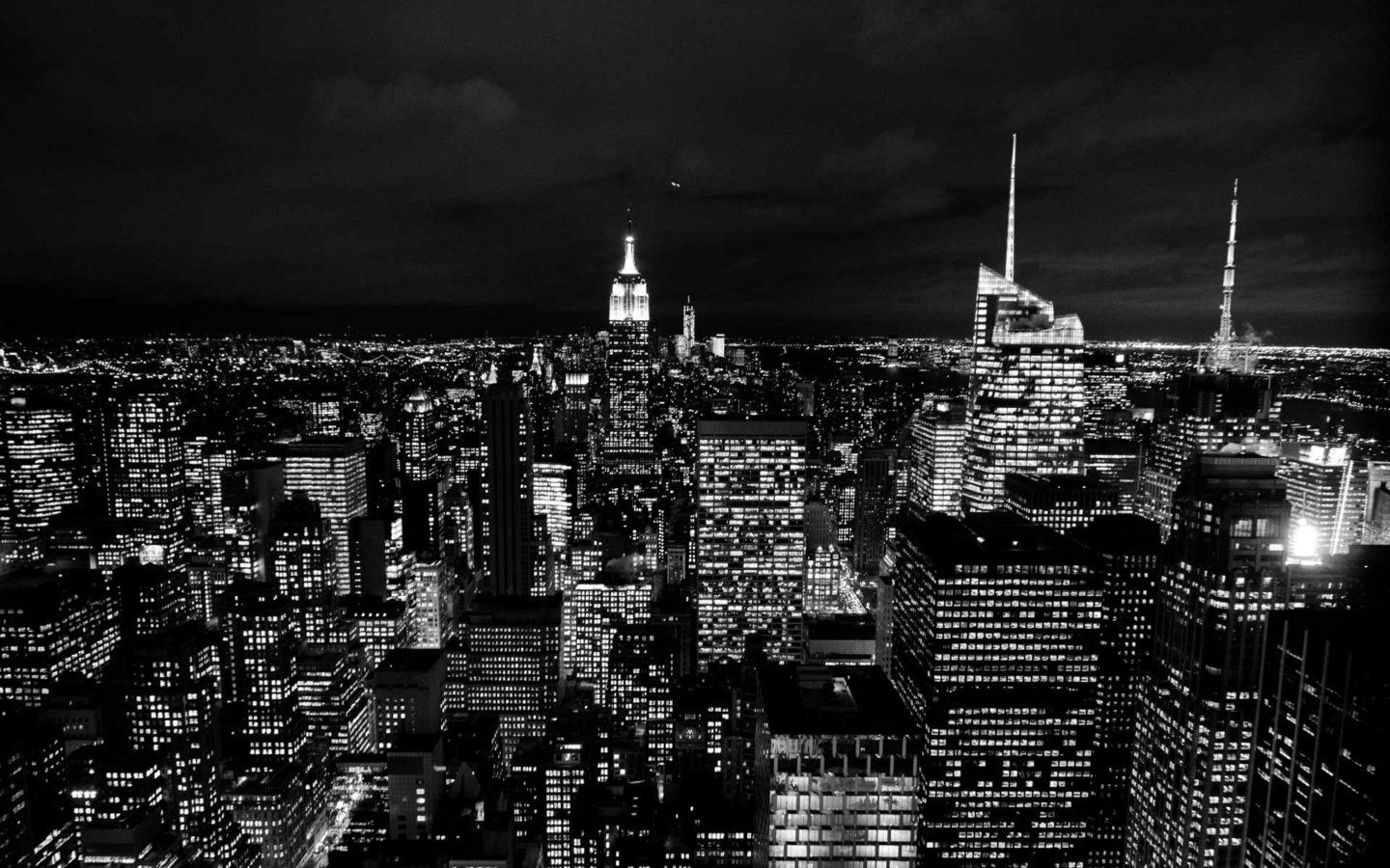 Black-and-white photo of skyscrapers in Manhattan at night