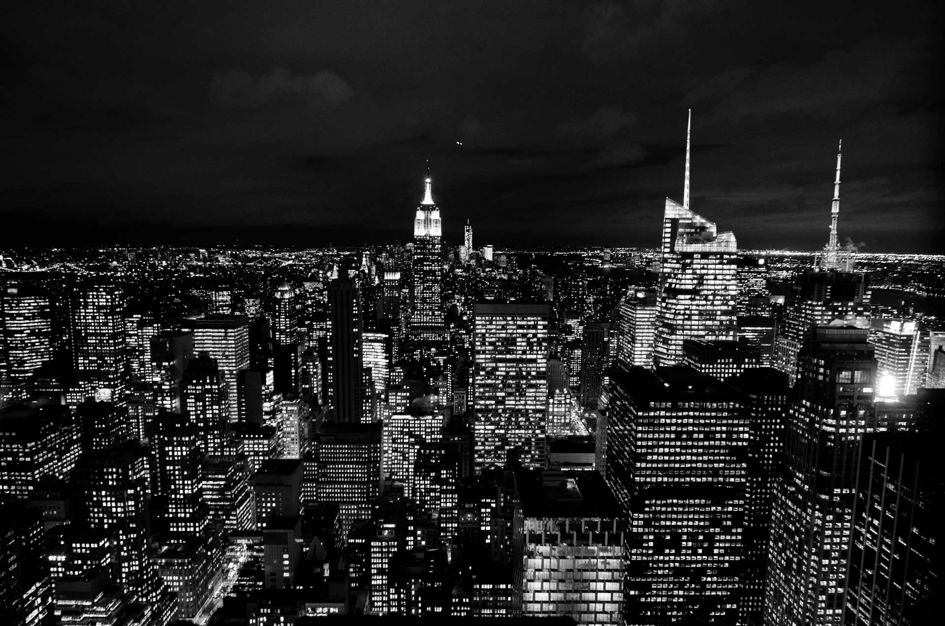 Black-and-white photo of skyscrapers in Manhattan at night
